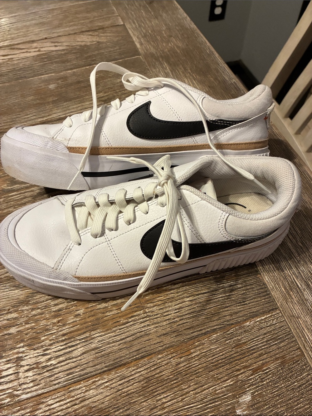 Nike White Leather Sneakers with Black Swoosh and Gold Stripe